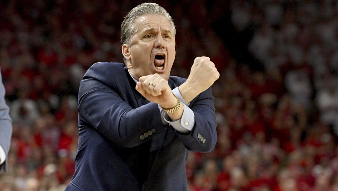 Kentucky coach John Calipari reacts as he calls for a flagrant foul against Arkansas during the second half of an NCAA college basketball game Saturday, Feb. 26, 2022, in Fayetteville, Ark.