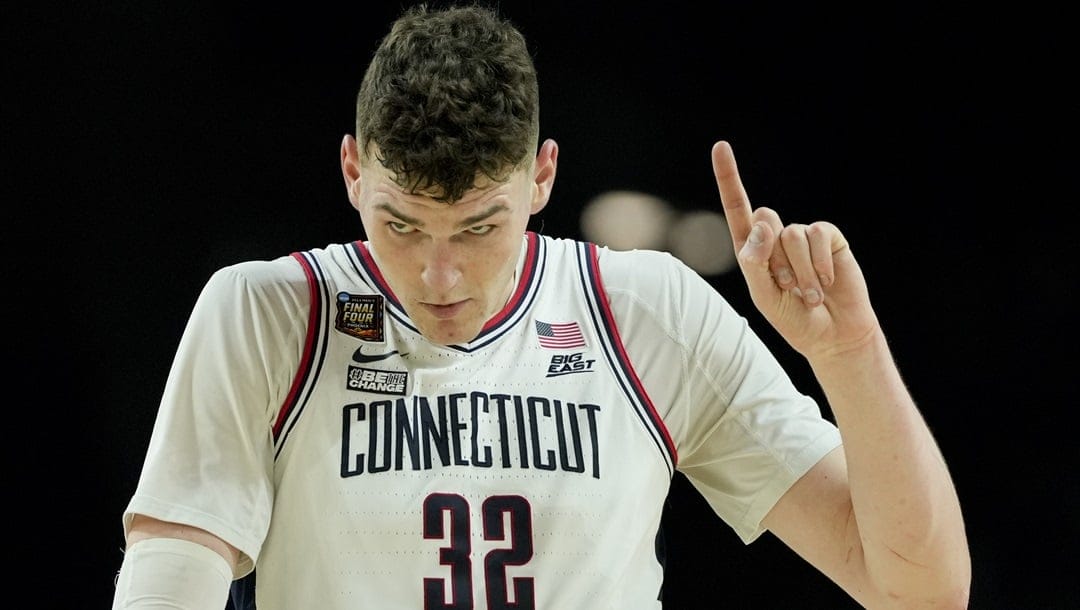 UConn center Donovan Clingan (32) celebrates after their win against Alabama in a NCAA college basketball game at the Final Four, Saturday, April 6, 2024, in Glendale, Ariz.