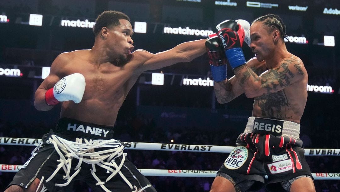 Devin Haney, left, throws a punch at Regis Prograis during the WBC super lightweight title boxing bout Saturday, Dec. 9, 2023.