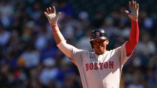 Boston Red Sox's Rafael Devers reacts to hitting a single against the Seattle Mariners during the first inning of a baseball game Sunday, March 31, 2024, in Seattle.