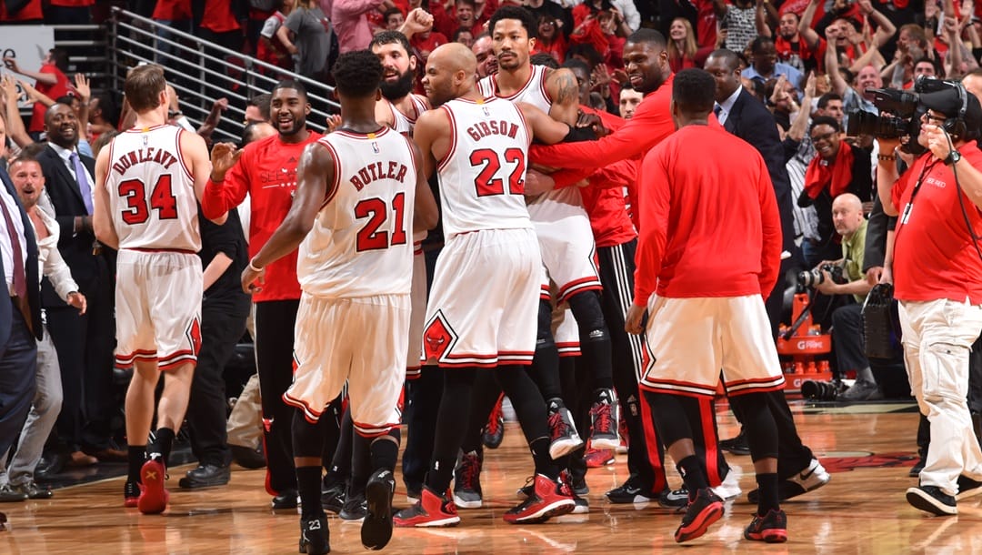 Derrick Rose #1 of the Chicago Bulls celebrates with teammates after hitting the game winning three pointer with three seconds left in the game against the Cleveland Cavaliers at the United Center During Game Two of the Eastern Conference Semifinals during the 2015 NBA Playoffs on May 8, 2015 in Chicago,Illinois