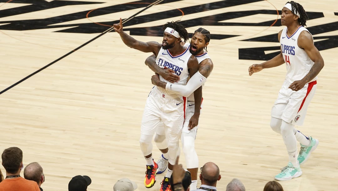 Patrick Beverley #21, Paul George #13, and Terance Mann #14 of the LA Clippers react during the fourth quarter in game two of the NBA Western Conference finals against the Phoenix Suns at Phoenix Suns Arena on June 22, 2021 in Phoenix, Arizona.