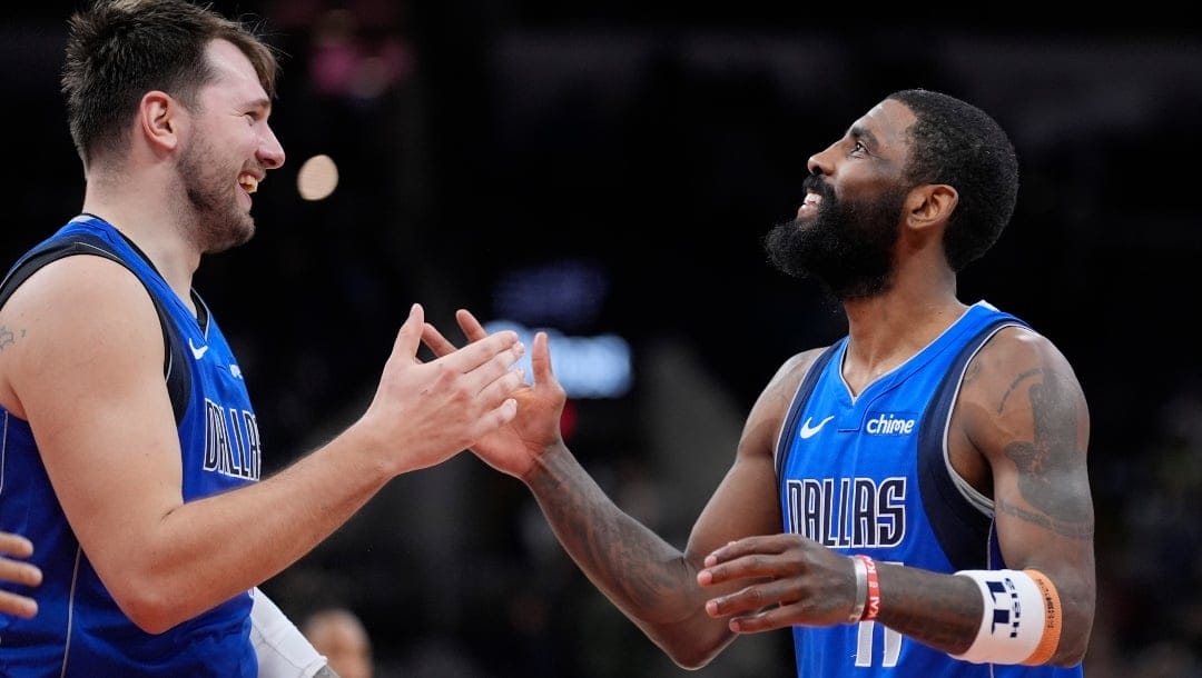 Dallas Mavericks guard Luka Doncic, left, and Dallas Mavericks guard Kyrie Irving, right, celebrate their win over the San Antonio Spurs in an NBA basketball game in San Antonio, Tuesday, March 19, 2024.