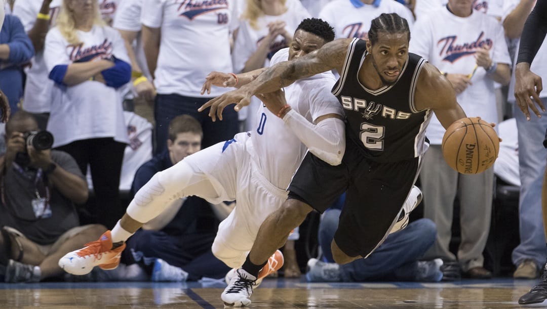 Kawhi Leonard #2 of the San Antonio Spurs and Russell Westbrook #0 of the Oklahoma City Thunder battle for the ball during the second half of Game Three of the Western Conference Semifinals during the 2016 NBA Playoffs at the Chesapeake Energy Arena on May 6, 2016 in Oklahoma City, Oklahoma.