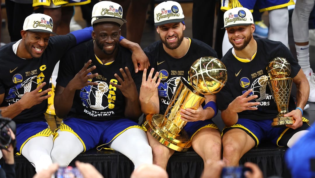 Andre Iguodala #9, Draymond Green #23, Klay Thompson #11 and Stephen Curry #30 of the Golden State Warriors pose for a photo after defeating the Boston Celtics 103-90 in Game Six of the 2022 NBA Finals at TD Garden on June 16, 2022 in Boston, Massachusetts.