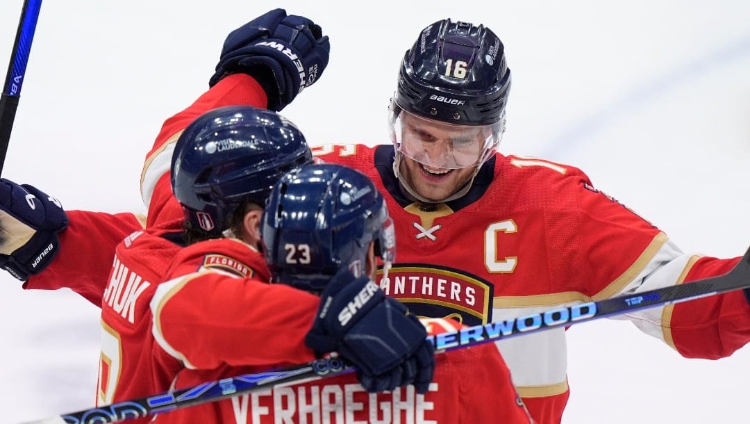 Florida Panthers center Aleksander Barkov (16) and left wing Matthew Tkachuk, left, congratulate center Carter Verhaeghe (23) after Verhaeghe scored a goal during the third period of Game 5 of the first-round of an NHL Stanley Cup Playoff series against the Tampa Bay Lightning, Monday, April 29, 2024, in Sunrise, Fla. (AP Photo/Wilfredo Lee)