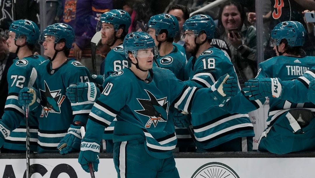 San Jose Sharks center Klim Kostin (10) is congratulated by teammates after scoring against the Seattle Kraken during the second period of an NHL hockey game in San Jose, Calif., Monday, April 1, 2024. (AP Photo/Jeff Chiu)