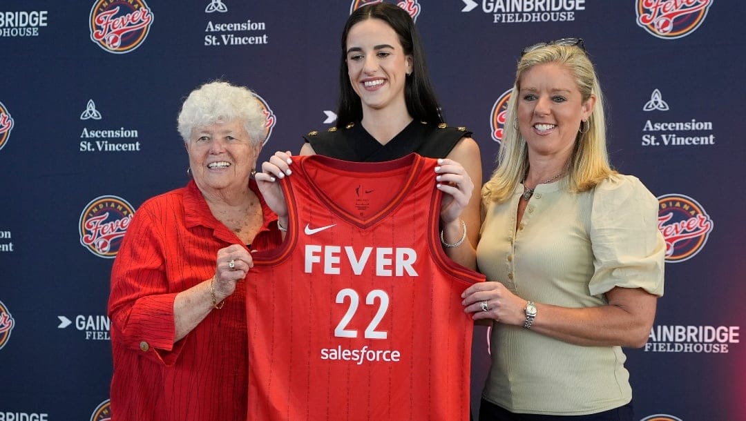 Indiana Fever's Caitlin Clark, middle, poses with general manager Lin Dunn, left, and head coach Christie Sides following a WNBA basketball news conference, Wednesday, April 17, 2024, in Indianapolis.