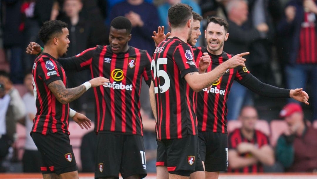 Bournemouth's Dominic Solanke celebrates with teammates after scoring his side's opening goal during the English Premier League soccer match between Bournemouth and Manchester United, at The Vitality Stadium in Bournemouth, England, Saturday, April 13, 2024.
