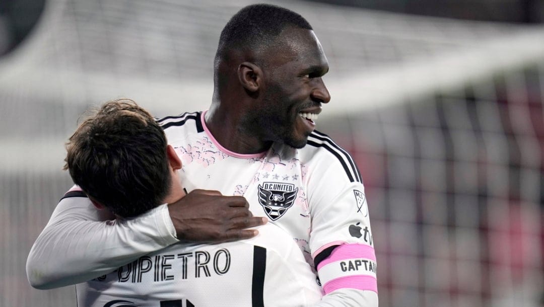 D.C. United's Christian Benteke, right, is congratulated by teammate Theodore Ku-DiPietro after scoring during the first half of an MLS soccer match against St. Louis City Saturday, March 23, 2024, in St. Louis.