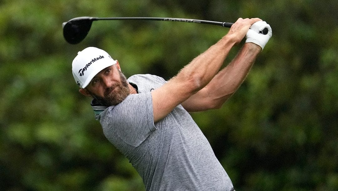 Dustin Johnson watches his shot on the 11th hole during a practice round in preparation for the Masters golf tournament at Augusta National Golf Club Tuesday, April 9, 2024, in Augusta, Ga.