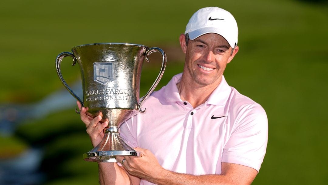 Rory McIlroy, of Northern Ireland, holds the trophy after winning the Wells Fargo Championship golf tournament at the Quail Hollow Club Sunday, May 12, 2024, in Charlotte, N.C.