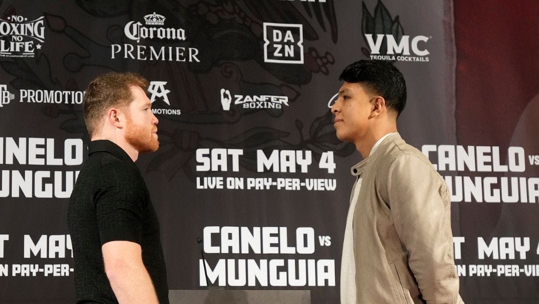 Undisputed super middleweight champion Canelo Alvarez, left, poses with boxer Jaime Munguía during a news conference.