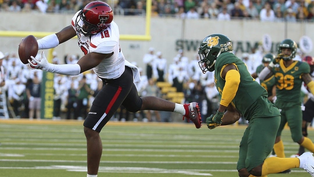 Texas Tech wide receiver Cameron Cantrell (18) catches a pass in front of Baylor safety Henry Black (8) during the second half of a NCAA college football game in Waco, Tex.,Saturday, Oct. 12, 2019.