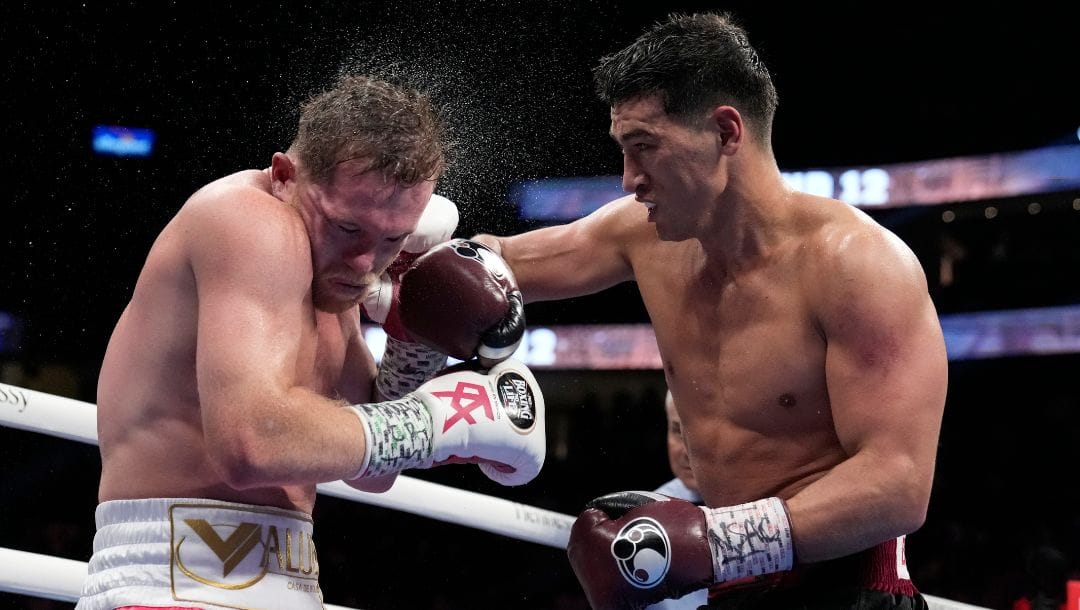 Dmitry Bivol, right, of Kyrgyzstan, throws a punch against Canelo Alvarez, of Mexico, during a light heavyweight title boxing.