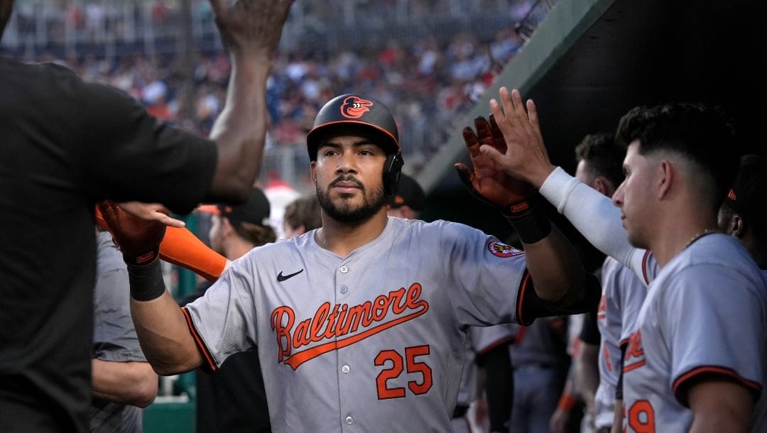 Baltimore Orioles' Anthony Santander (25) is congratulated in the dugout after his solo home run against the Washington Nationals during the fourth inning of a baseball game at Nationals Park in Washington, Wednesday, May 8, 2024.