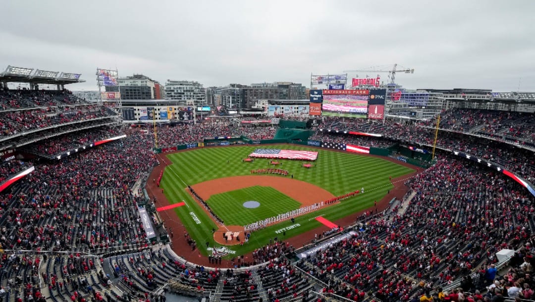 The Pittsburgh Pirates and Washington Nationals stand on the field during the national anthem before an opening day baseball game in this general view at Nationals Park, Monday, April 1, 2024, in Washington. Pirates won 8-4.