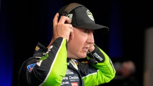 Kyle Busch removes his headphones at the end of an interview during NASCAR Daytona 500 auto racing media day at Daytona International Speedway, Wednesday, Feb. 14, 2024, in Daytona Beach, Fla. (AP Photo/John Raoux)