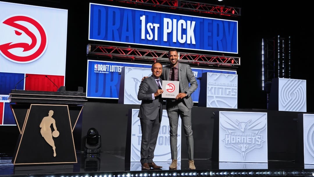 Landry Fields of the Atlanta Hawks poses for a photo with Mark Tatum after winning the number one overall pick during the 2024 NBA Draft Lottery on May 12, 2024 at McCormick Convention Center in Chicago, Illinois.