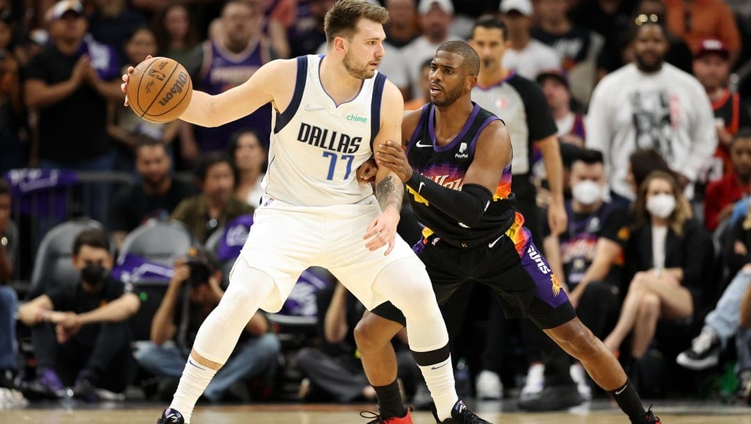 Luka Doncic #77 of the Dallas Mavericks handles the ball against Chris Paul #3 of the Phoenix Suns in Game Seven of the 2022 NBA Playoffs Western Conference Semifinals at Footprint Center on May 15, 2022 in Phoenix, Arizona.