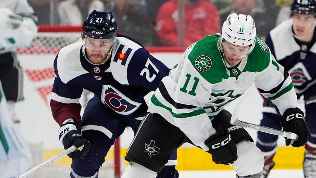 Colorado Avalanche left wing Jonathan Drouin (27) and Dallas Stars center Logan Stankoven (11) in the second period of an NHL hockey game Tuesday, Feb. 27, 2024, in Denver. (AP Photo/David Zalubowski)