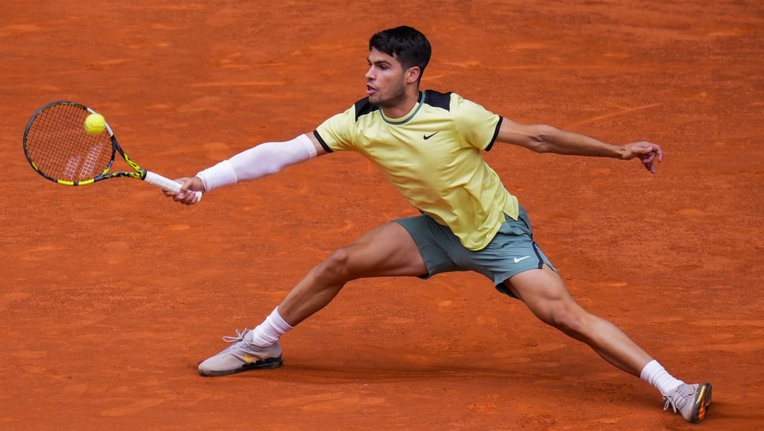 Carlos Alcaraz, of Spain, returns the ball to Jan-Lennard Struff, of Germany, during the Mutua Madrid Open tennis tournament in Madrid, Tuesday, April 30, 2024.