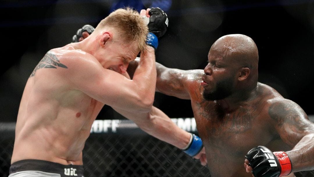 Derrick Lewis, right, punches Alexander Volkov during a heavyweight mixed martial arts bout at UFC 229 in Las Vegas.