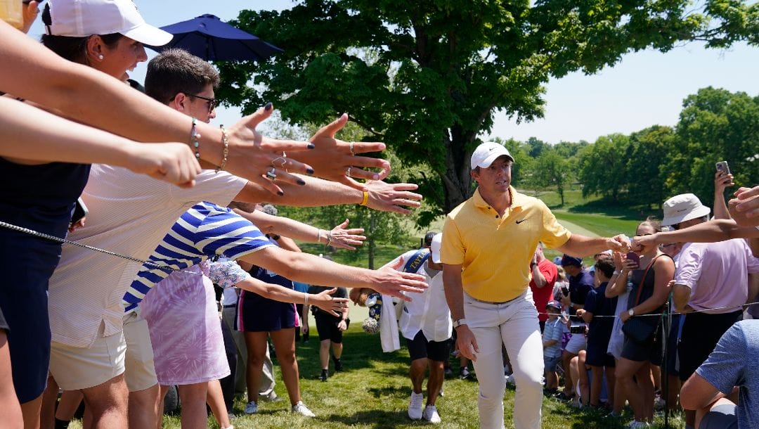 Rory McIlroy, of Northern Ireland, greets fans as he walks to the fifth tee during the final round of the Memorial golf tournament, Sunday, June 4, 2023, in Dublin, Ohio.