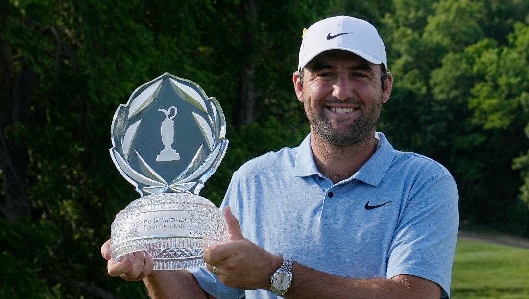 Scottie Scheffler poses for a photo with the trophy after winning the Memorial golf tournament, Sunday, June 9, 2024, in Dublin, Ohio.