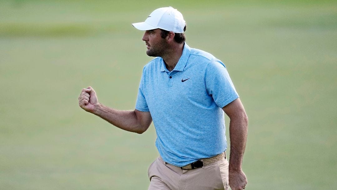 Scottie Scheffler pumps his fist after putting on the 16th green during the final round of the Memorial golf tournament, Sunday, June 9, 2024, in Dublin, Ohio.