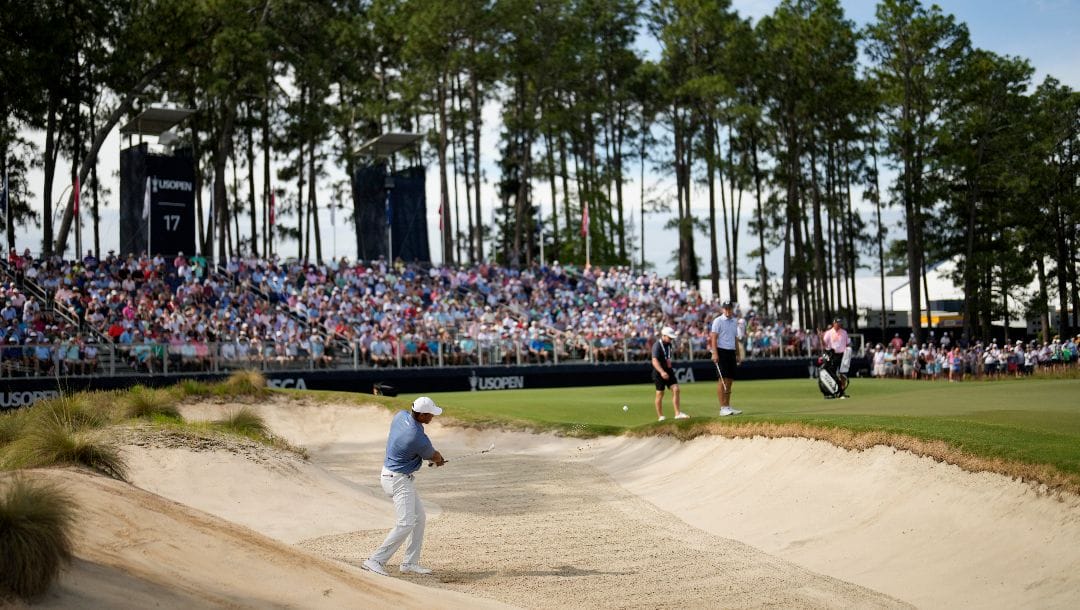 Tiger Woods hits from the bunker on the 17th hole during a practice round for the U.S. Open golf tournament Monday, June 10, 2024, in Pinehurst, N.C.