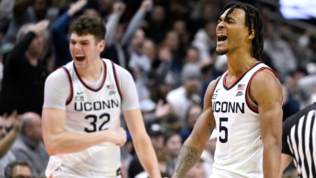 UConn center Donovan Clingan (32) and UConn guard Stephon Castle (5) react in the second half of an NCAA college basketball game against Creighton, Wednesday, Jan. 17, 2024, in Storrs, Conn.