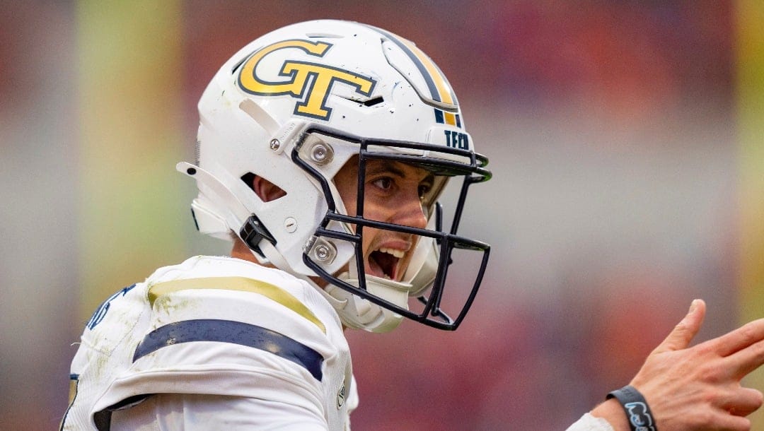 Georgia Tech quarterback Haynes King (10) reacts after scoring a touchdown during the first half of an NCAA college football game against Clemson, Saturday, Nov. 11, 2023, in Clemson, S.C. (AP Photo/Jacob Kupferman)
