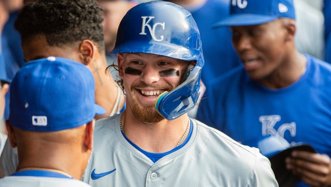 Kansas City Royals' Bobby Witt Jr. is greeted in the dugout after hitting two-run home run off Cleveland Guardians starting pitcher Triston McKenzie during the third inning of a baseball game in Cleveland, Tuesday, June 4, 2024.