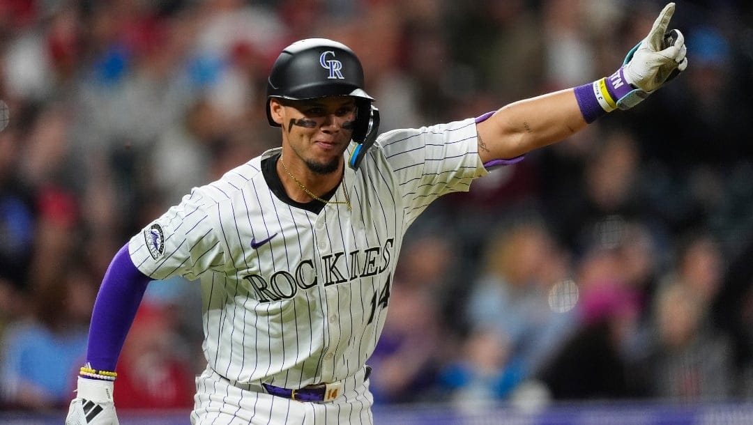 Colorado Rockies' Ezequiel Tovar gestures as he heads up the first base line after connecting for a walkoff RBI single off Philadelphia Phillies relief pitcher Gregory Soto in the 11th inning of a baseball game Friday, May 24, 2024, in Denver.