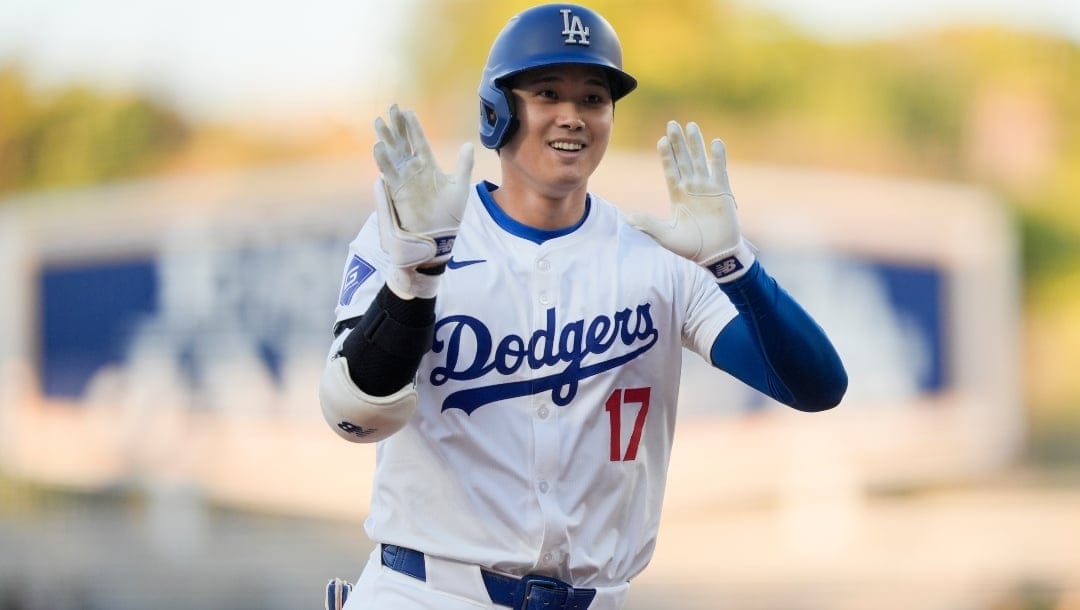 Los Angeles Dodgers designated hitter Shohei Ohtani celebrates his solo-home run during the first inning of a baseball game against the Texas Rangers, Wednesday, June 12, 2024, in Los Angeles.