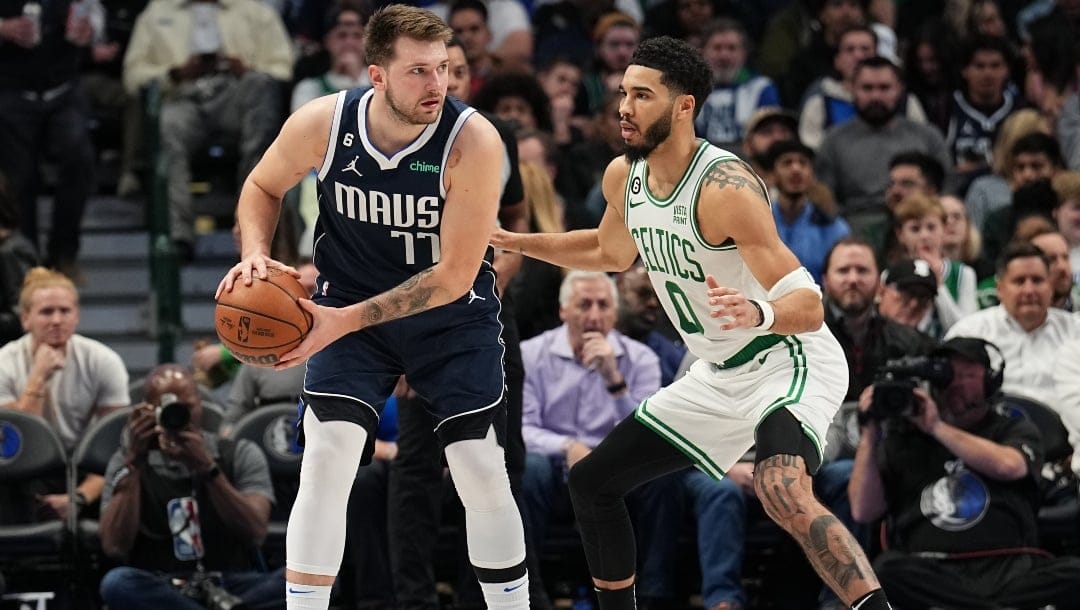 Jayson Tatum #0 of the Boston Celtics guards Luka Doncic #77 of the Dallas Mavericks during the game between the Boston Celtics and the Dallas Mavericks on January 5, 2022 at the American Airlines Center in Dallas, Texas.