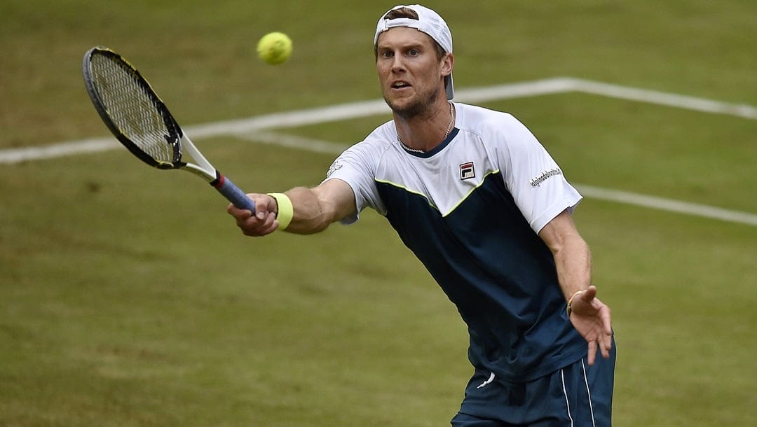 Andreas Seppi of Italy returns the ball to Gael Monfils of France during their quarterfinal match at the Gerry Weber Open ATP tennis tournament in Halle, Germany, Friday, June 19, 2015.