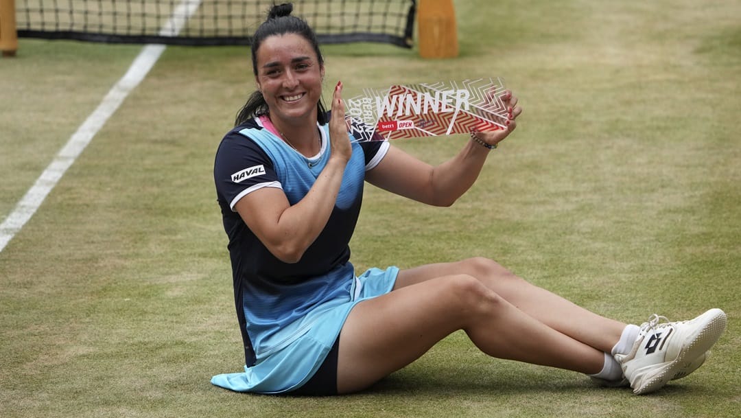 Ons Jabeur from Tunesia poses with trophy after winning the final tennis match of the WTA tournament against Belinda Bencic from Switzerland in Berlin, Germany, Sunday, June 19, 2022.