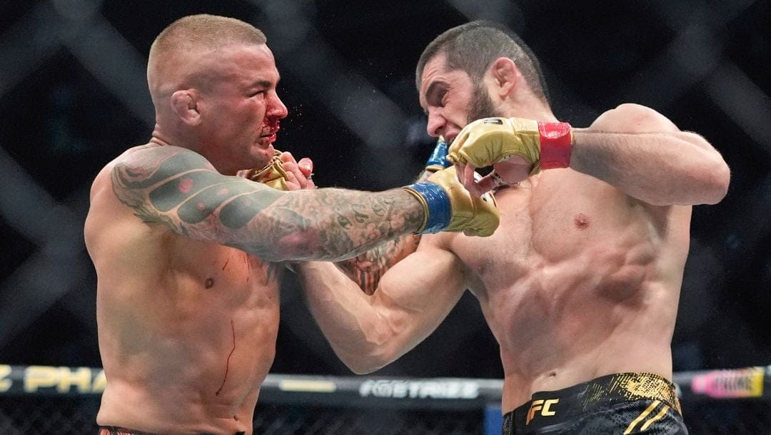 Russia's Islam Makhachev, right, punches Dustin Poirier, during the third round of a lightweight title bout at the UFC 302.