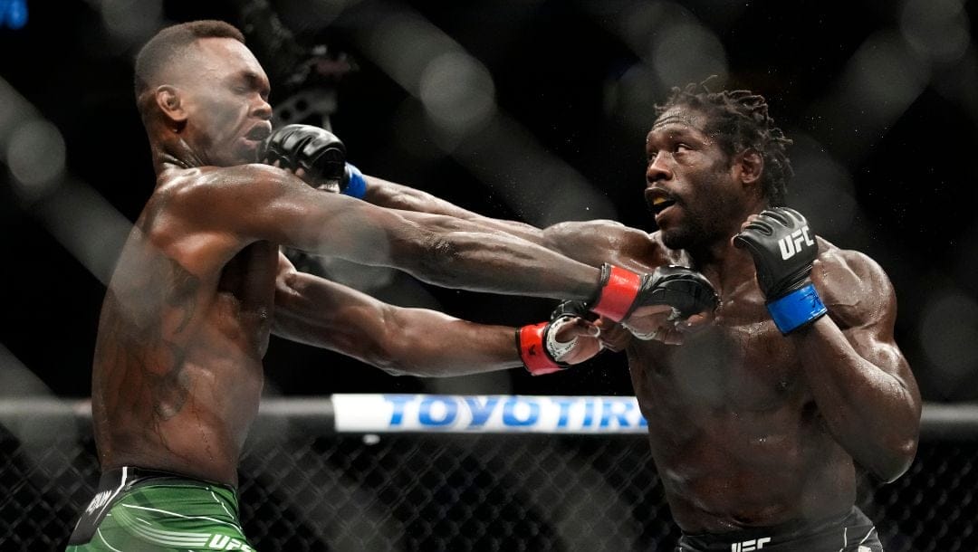 Jared Cannonier, right, hits Israel Adesanya in a middleweight title bout during the UFC 276 mixed martial arts event.