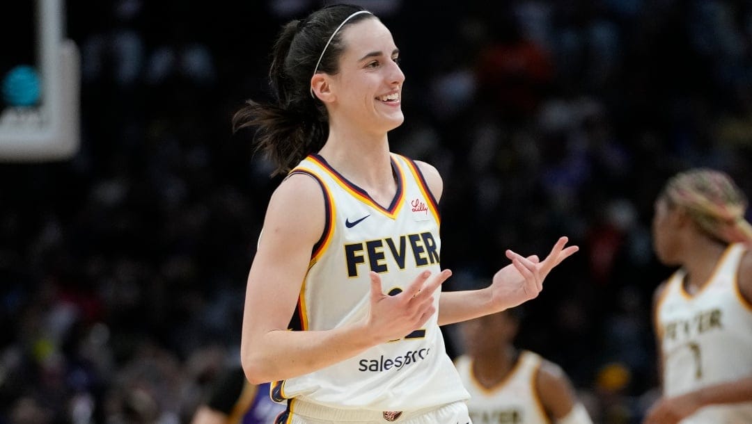 Indiana Fever guard Caitlin Clark (22) celebrates after making a 3-pointer during the second half of a WNBA basketball game against the Los Angeles Sparks in Los Angeles, Friday, May 24, 2024.