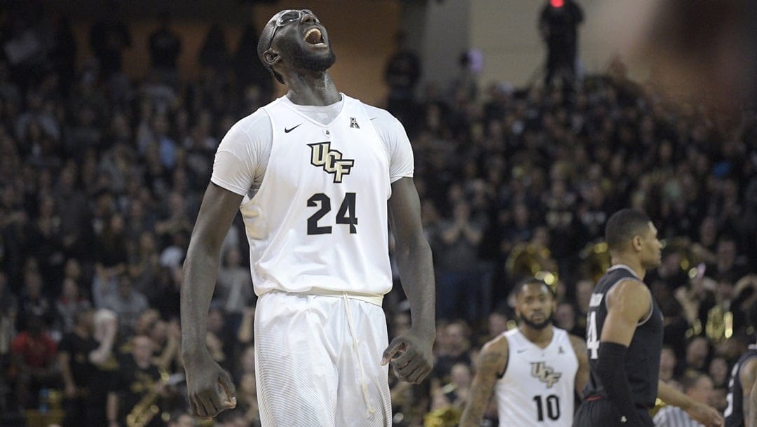 Central Florida center Tacko Fall (24) celebrates after a score by the team during the first half of an NCAA college basketball game against Cincinnati Tuesday, Jan. 16, 2018, in Orlando, Fla. Cincinnati won 49-38.