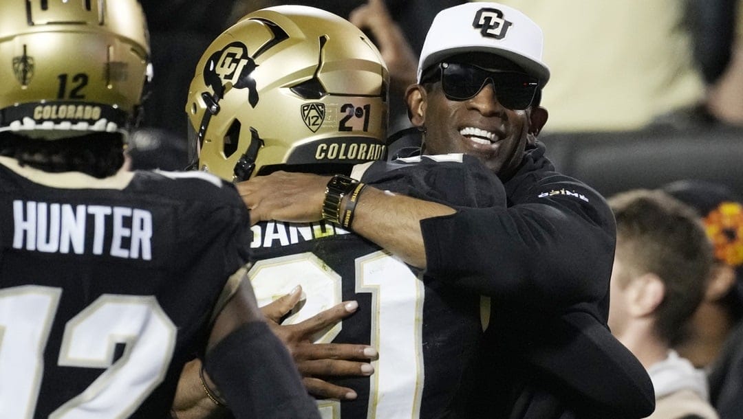 Colorado head coach Deion Sanders, right, hugs his son, safety Shilo Sanders, after he returned an interception for a touchdown in the first half of an NCAA college football game against Colorado State Saturday, Sept. 16, 2023, in Boulder, Colo.