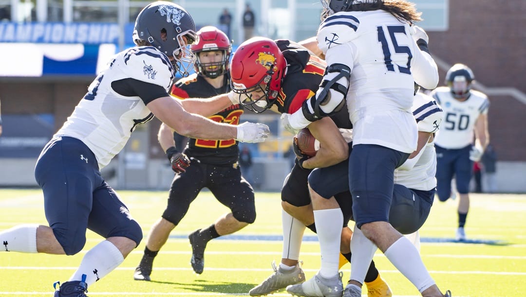 Ferris State wide receiver Dezmin Lyburtus (11) is tackled by Colorado School of Mines safety Jaden Williams (32) in the first half of the NCAA Division II college football championship on Saturday, Dec. 17, 2022 in McKinney, Texas.