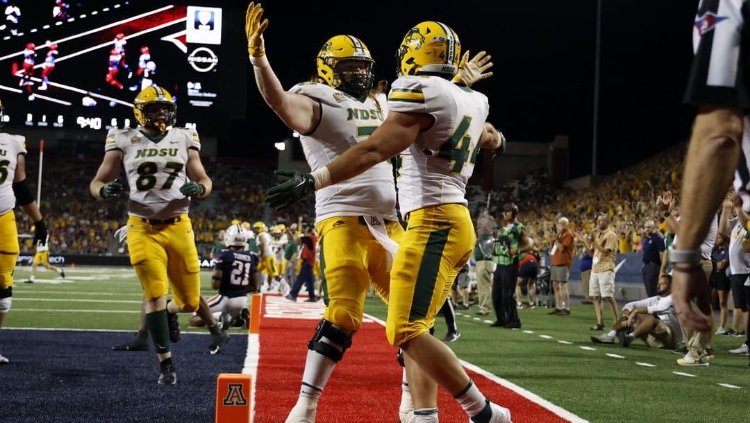 North Dakota State fullback Hunter Luepke (44) hugs offensive tackle Cody Mauch after scoring a touchdown against Arizona during the second half of an NCAA college football game Saturday, Sept. 17, 2022, in Tucson, Ariz.