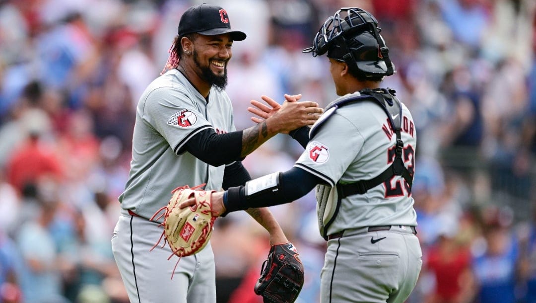 Cleveland Guardians' Emmanuel Clase, left, and Bo Naylor, right, celebrate after the final out of a baseball game against the Philadelphia Phillies, Sunday, July 28, 2024, in Philadelphia.