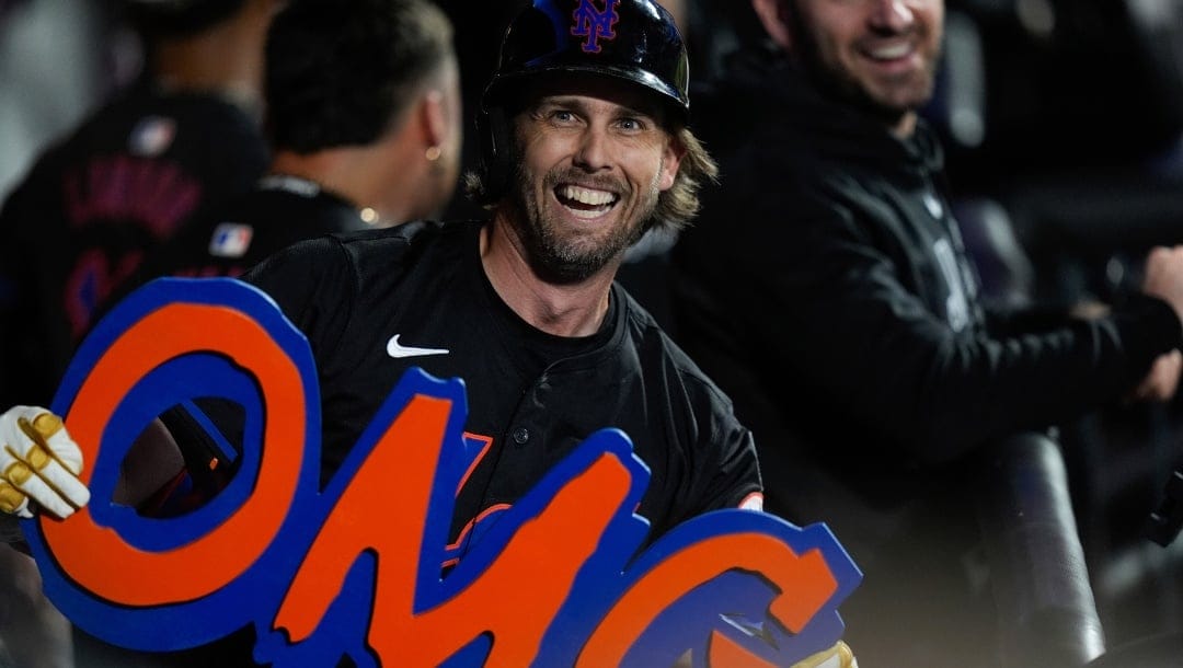New York Mets' Jeff McNeil poses for photos after hitting a three-run home run against the Houston Astros during the sixth inning of a baseball game Friday, June 28, 2024, in New York.