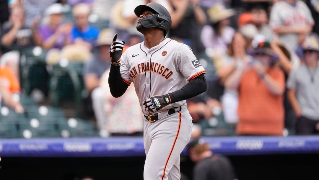 San Francisco Giants' Jorge Soler gestures as he crosses home plate after hitting a solo home run off Colorado Rockies starting pitcher Ryan Feltner in the first inning of a baseball game, Sunday, July 21, 2024, in Denver.