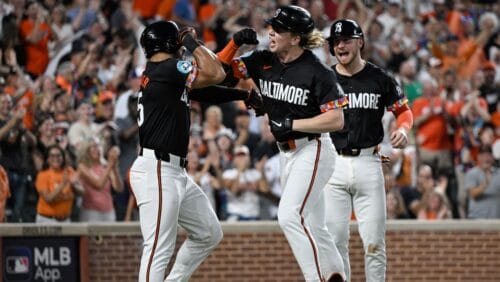 Baltimore Orioles' Heston Kjerstad, center, celebrates after his grand slam off Texas Rangers pitcher Michael Lorenzen with Anthony Santander, left, during the fifth inning of a baseball game, Saturday, June 29, 2024, in Baltimore.